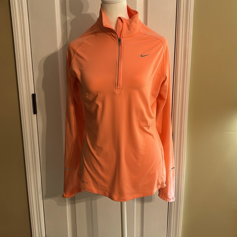 Dri-Fit women’s Nike pretty peach color with reflective strip on sleeve